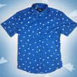 Load image into Gallery viewer, A complete view of the adult 7-Strong "Paper Planes" button down shirt - featuring various sizes and designs of paper airplanes, some with dotted trails behind them against a royal blue background. The shirt is displayed against a faced background of the shirt details.