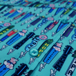 Load image into Gallery viewer, Midsection button view of the 7-Strong adult "I'd Tap That" shirt - in a bright seafoam green color, the shirt features rows of custom beer tap handles modeled after previous 7-Strong designs.