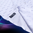 Load image into Gallery viewer, A sweep tag view of the 7-Strong "Stay" button down, a white shirt with staggered, hollowed out semicolons outlined in teal and purple - the colors for suicide awareness. The shirt is on a purple and teal wispy, illuminated background.