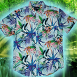 Load image into Gallery viewer, Full, centered close up view of the 7-Strong "Tropic of Conversation" adult button down shirt - featuring several different floral plants in large, vibrant print against a faded background of other plants and florals. The shirt is featured against a lush, green rainforest background.