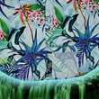 Load image into Gallery viewer, Bottom sweep tag portion view of the 7-Strong "Tropic of Conversation" adult button down shirt - featuring several different floral plants in large, vibrant print against a faded background of other plants and florals. The shirt is featured against a lush, green rainforest background.