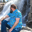 Load image into Gallery viewer, Male model sitting on a rock looking over his shoulder at a waterfall wearing the 7-Strong Avocado Coast button down.