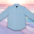 Load image into Gallery viewer, Full centered view view of the baby blue long sleeve EveryWEAR adult button up. Pattern is subtle white 7-Bolts lined up all against each other across a baby blue background. The shirt is featured on a soft background of a wave hitting the beach.
