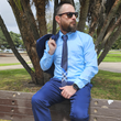 Load image into Gallery viewer, Shot of a male model, on a bench looking off into the distance in a blue suit accented by the 7-Strong EveryWEAR collection baby blue long sleeve shirt.