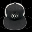 Load image into Gallery viewer, Close up centered shot of the 7-Strong black "Branded" trucker hat with raised X-Badge patch centered on the front of the hat. Product is featured against a black geometric background.