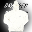Load image into Gallery viewer, Full centered, arms-folded view of the front of the 7-Strong white 'Branded' hoodie, featuring a black 7-bolt logo on the left chest and a small tag on the hip opening. Hoodie is featured against a half black/half white background with the word "BRANDED" written three times down the middle.