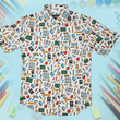 Load image into Gallery viewer, Full centered of 7-Strong Class act button-down featuring various classroom items such as pencils, rulers, globes, notebooks, apples, protractors, etc against a white graph paper background. Shirt is against a background of school supplies.