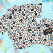 Load image into Gallery viewer, Full view of 7-Strong Class act button-down - in both adult and youth -featuring various classroom items such as pencils, rulers, globes, notebooks, apples, protractors, etc against a white graph paper background. Shirt is against a background of school supplies.