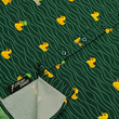 Load image into Gallery viewer, A bottom sweep tag view of the 7-Strong "Duck O' The Irish" youth button down, featuring a deep green water-replicating background with various rubber ducks swimming along the waves. The shirt is featured against a green river scenic with a giant inflatable duck in the background.