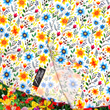 Load image into Gallery viewer, A bottom half close-up shot of the 7-Strong "Daisy Me Rollin'" adult button down shirt, a white base color with various blue, red, orange, and yellow floral daisies in an all over print. The shirt is displayed against a background of a field of daisies.