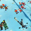 Load image into Gallery viewer, A midsection close up of the adult 8-Bit Hat Trick button down - featuring various 8-bit inspired scenes from hockey games on a light blue ice-like background. The shirt is featured against a ice hockey floor with hats strewn about.