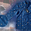 Load image into Gallery viewer, Full layout of "Call Me Old Fashioned" adult long sleeve button-down. Features elements of an Old Fashioned cocktail (bottle of bourbon, glasses, oranges, stirrers, and ice) against a blue background which faintly spells out an Old Fashioned recipe. Shirt is on a background featuring a finished Old Fashioned and has a detail circle in the bottom left corner showing design detail. The shirt is displayed on the background of a bartender making an old fashioned cocktail.