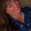 Load image into Gallery viewer, Female model smiling at camera wearing the "Call Me Old Fashioned" adult long sleeve button-down. Features elements of an Old Fashioned cocktail (bottle of bourbon, glasses, oranges, stirrers, and ice) against a blue background which faintly spells out an Old Fashioned recipe.
