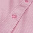 Load image into Gallery viewer, Mid pocket tag view of the pink short sleeve EveryWEAR adult button up. Pattern is subtle white 7-Bolts lined up all against each other across a pink background. The shirt is featured on a soft background of a wave hitting the beach.