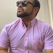Load image into Gallery viewer, Medium shot of a male model gazing off wearing the pink short sleeve EveryWEAR adult button up. Pattern is subtle white 7-Bolts lined up all against each other across a pink background.