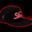 Load image into Gallery viewer, Full side look at the Black 7-Strong Sideline Script hat, with white embroidered SEVEN and red puff scripted STRONG across the front. Along with an embroidered red 7-bot on the side. Hat is on the back of a red and black fusion background.