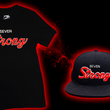 Load image into Gallery viewer, 3/4 look at the Black 7-Strong Sideline Script tee, with white SEVEN and red scripted STRONG across the chest. Alongside the 7-Strong Sideline Script snapback hat, with the same features but as a puffed embroidery. Shirt and tee are on the back of a red and black fusion background.