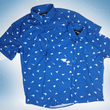 Load image into Gallery viewer, A complete view of both adult and youth 7-Strong "Paper Planes" button down shirts overlapping one another - featuring various sizes and designs of paper airplanes, some with dotted trails behind them against a royal blue background. The shirt is displayed against a faced background of the shirt details.