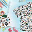 Load image into Gallery viewer, Offcentered view of 7-Strong Class Act youth button-down featuring various classroom items such as pencils, rulers, globes, notebooks, apples, protractors, etc against a white graph paper background. Shirt is against a background of school supplies. Bottom left features a detail circle showing a close up of some of the items on the shirt.