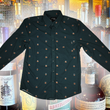 Load image into Gallery viewer, Full display view of the 7-Strong "Straight Sippin'" long Sleeve button down. The shirt is a deep green with black ripples as its background, while the foreground has various drinking glasses with various levels of whiskey, some with ice, others without. The shirt is shown against a background of various whiskies and bourbons on a shelf.