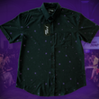 Load image into Gallery viewer, Full view of the 7-Strong "Flux Capacity" short sleeve button down, showcasing bursts and lines of purple light peering through a black grid of cubes. The background is of a fashion show runway in purple hue.