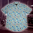 Load image into Gallery viewer, Full view of the 7-Strong "Cheat Day" adult button down featuring various snacks, treats, and fast food features on a light blue shirt. The shirt is displayed against a background of a gym weight rack.