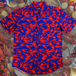 Load image into Gallery viewer, Full view of the 7-Strong Dat Boil shirt in deep navy blue with red crawfish patterned throughout overlapping one another. The shirt itself sits on a background image of items from a Crawfish Boil such as crawfish, seasoning, corn, and potatoes.