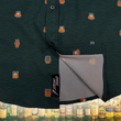 Load image into Gallery viewer, Bottom sweep tag view of the 7-Strong "Straight Sippin'" Short Sleeve button down. The shirt is a deep green with black ripples as its background, while the foreground has various drinking glasses with various levels of whiskey, some with ice, others without. The shirt is shown against a background of various whiskies and bourbons on a shelf.