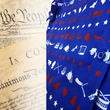 Load image into Gallery viewer, A close up representation of 7-Strong's 1776 button down shirt, in the middle button region, against a Declaration of Independence background. Shirt is royal blue with stripes of various Americana icons, including the original 13 colonies and revolutionary war items.