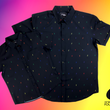 Load image into Gallery viewer, Full view of both adult and youth short sleeve button down shirts, black as base color and adorned with multicolored version of our 7-Bolt design. Shirt is on a multicolor gradient-like background, in the bottom right, the logo for onePULSE Foundation, our cause collection partner.
