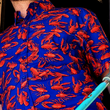 Load image into Gallery viewer, Medium shot of adult male model of medium build wearing the 7-Strong Dat Boil shirt in deep navy blue with red crawfish patterned throughout overlapping one another.