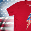 Load image into Gallery viewer, 3/4 view of the red Freedom Bolt unisex tee, featuring a large center placed 7-bolt, outlined in gold, with white stars on blue on top and red and white stripes on the bottom. The shirt is featured on a U.S. flag background.