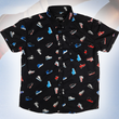 Load image into Gallery viewer, Full centered view of the youth short sleeve version of "Got 'Em!" The button down features various athletic fashion sneakers in an 80bit format arranged all over a black shirt. The shirt is featured against a background of a basketball player jumping in air, noticeable sneakers being worn.