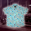 Load image into Gallery viewer, Full view of the 7-Strong "Cheat Day" youth button down featuring various snacks, treats, and fast food features on a light blue shirt. The shirt is displayed against a background of a gym weight rack