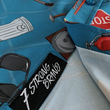Load image into Gallery viewer, Sweep tag view of the 7-Strong "TLC OMG" shirt, a homage to wrestling objects featured all over the shirt including tables, ladders, chairs, ring bells, sledgehammers, brass knuckles, championships, guitars, stop signs, microphones amongst other items. The items are on a blue shirt with a faded steel cage background.