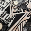 Load image into Gallery viewer, Midsection button view of the youth 7-Strong "Cinco de Mayhem" button down shirt. Shirt features black and white posters featuring various created luchadors advertised for matches, all overlapping each other over a black shirt. Shirt is displayed on a black gradient background with some of the characters ghosted in the back.