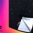 Load image into Gallery viewer, Close up, focusing on sweep tag portion of short sleeve adult button down shirt, black as base color and adorned with multicolored version of our 7-Bolt design. Shirt is on a multicolor gradient-like background, and on the bottom left, the logo for onePULSE Foundation, our cause collection partner.