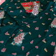 Load image into Gallery viewer, Mediun view of the long-sleeve, adult and youth short-sleeve 7-Strong "Oh, Christmas Treat" shirts, overlapping one another - a green, christmas sweater-like background with columns of various white Christmas tree shaped cakes with red garland, some whole, some bitten. The shirt is displayed against a red, snowing background with a similar parted cake.