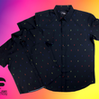 Load image into Gallery viewer, Full view of both adult and youth short sleeve button down shirts, black as base color and adorned with multicolored version of our 7-Bolt design. Shirt is on a multicolor gradient-like background, in the bottom left, the logo for onePULSE Foundation, our cause collection partner.
