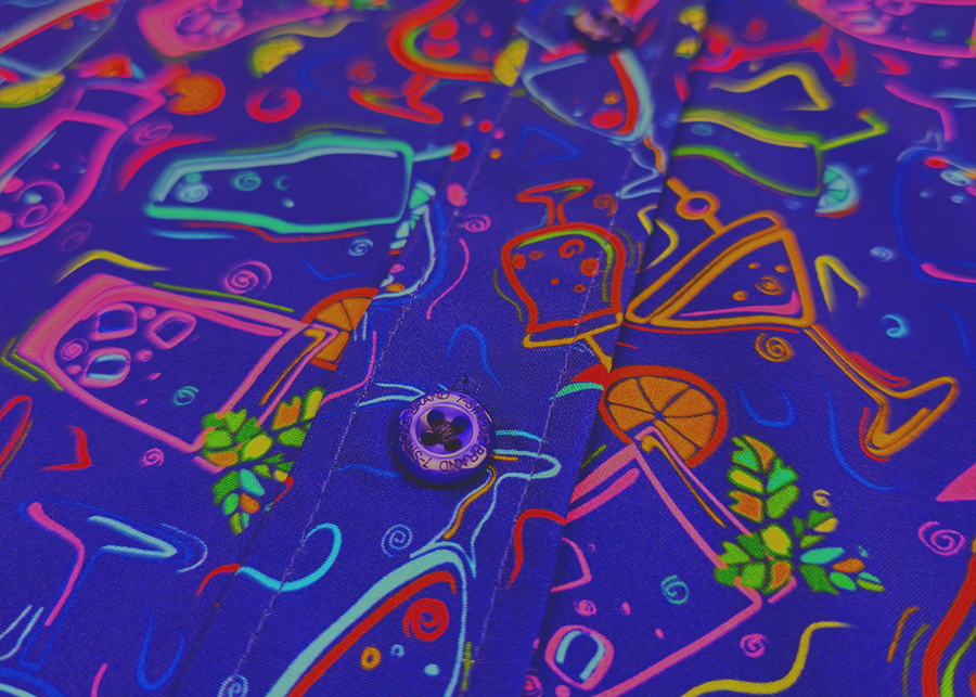 Midsection button view of the 7-Strong "Happy Hour" button down shirt, featuring a multitude of neon colored drinks and glassware with garnishes, mixes, and the like all over a deep purple background. The shirt is displayed against a gradient purple background with a neon sign signaling "Happy Hour."