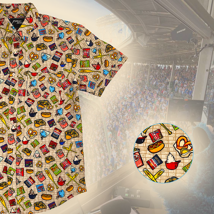 Colorful t-shirt with a pattern of food items displayed in front of a stadium.