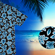Load image into Gallery viewer, 3/4 view of the 7-Strong adult Electric Palms shirt, a collection of electric blue palm fronds featured against a black shirt. Shirt is displayed against a scenic beach background. Bottom right features a detail circle showing the design up close.
