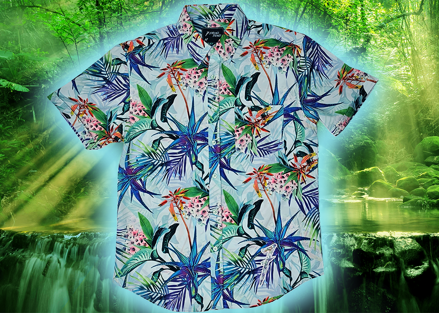 Full, centered close up view of the 7-Strong "Tropic of Conversation" adult button down shirt - featuring several different floral plants in large, vibrant print against a faded background of other plants and florals. The shirt is featured against a lush, green rainforest background.