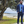 Load image into Gallery viewer, Shot of a male model, on a beach path looking off into the distance in a blue suit accented by the 7-Strong EveryWEAR collection baby blue long sleeve shirt. 
