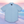Load image into Gallery viewer, Full centered view of the baby blue short sleeve EveryWEAR adult button up. Pattern is subtle white 7-Bolts lined up all against each other across a baby blue background. The shirt is featured on a soft background of a wave hitting the beach.
