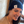 Load image into Gallery viewer, Female model smiling and looking away while wearing the black 7-Bolt beanie, reaching up to playfully adjust it.
