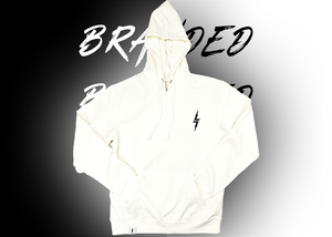 Full centered, arms-folded view of the front of the 7-Strong white 'Branded' hoodie, featuring a black 7-bolt logo on the left chest and a small tag on the hip opening. Hoodie is featured against a half black/half white background with the word "BRANDED" written three times down the middle.