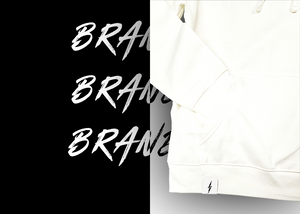 3/4, left aligned view of the front of the 7-Strong white 'Branded' hoodie, featuring a small 7-bolt logo tag on the hip opening. Hoodie is featured against a half black/half white background with the word "BRANDED" written three times down the middle.
