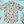 Load image into Gallery viewer, Full centered of 7-Strong Class act button-down featuring various classroom items such as pencils, rulers, globes, notebooks, apples, protractors, etc against a white graph paper background. Shirt is against a background of school supplies. 
