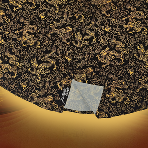 Black fabric with gold dragon pattern on a gold background